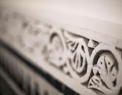 a wooden bench with a carving on the side of it at Palais Fes Yahya - family hosting in Fès al Bali