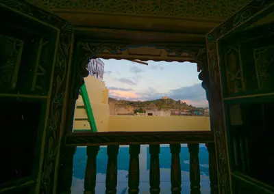 a view of the ocean through a window at Palais Fes Yahya - family hosting in Fès al Bali