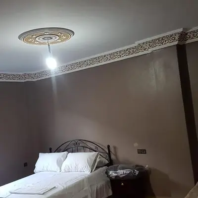 a bedroom with a bed with a ceiling at Auberge Restaurant Fatihi Freres in Tinerhir