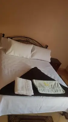 a bed with two towels and pillows on it at Auberge Restaurant Fatihi Freres in Tinerhir