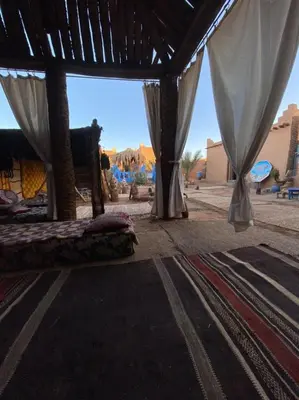 a room with two beds and a view of the desert at Auberge Kasbah Dar Sahara Tours in Mhamid