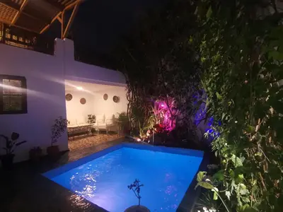 a swimming pool in a backyard at night at Dar Ben Daoud avec piscine et terrasse privee in Fès