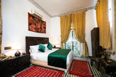 a bedroom with a bed and a window at Dar Ben Daoud avec piscine et terrasse privee in Fès