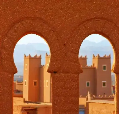 a view of a city through two archways in a building at La perle de saghro in Nkob