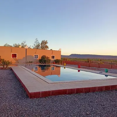 a house with a pool in front of a building at LESCALE DE OUARZAZATE in Ouarzazate