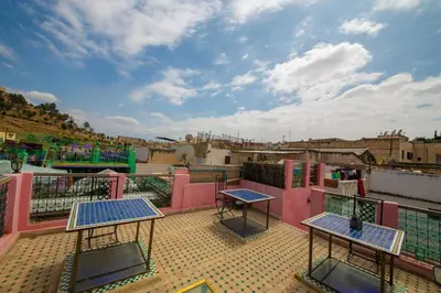 a patio with two tables on top of a building at Riad Fes Hayat - Confort Stay in Fès