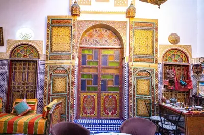 a room with a wall with colorful doors at Riad Fes Hayat - Confort Stay in Fès