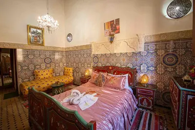a bedroom with a bed and a couch at Riad Fes Hayat - Confort Stay in Fès