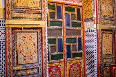 a wall with many different types of colorful doors at Riad Fes Hayat - Confort Stay in Fès