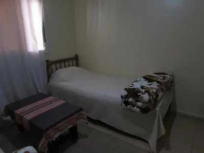 a small bedroom with a bed and a window at Bed and breakfast in Ifrane