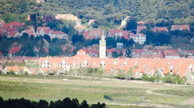 a town with red roofed houses and a church at Bed and breakfast in Ifrane