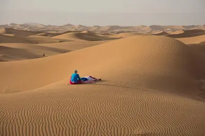 a man sitting on a camel in the desert at Oasis Tilogui-Luxury Hotel Restaurant and Desert Excursions In Zagora in Zagora