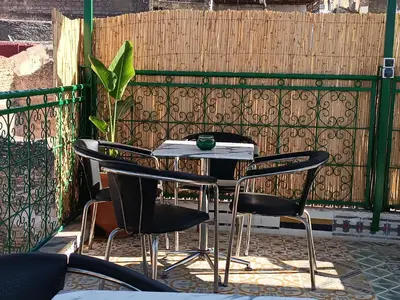 a table and chairs in front of a fence at Riad Safir Medina Fes in Fès