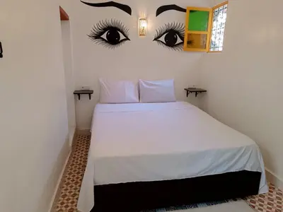 a bedroom with a bed with eyes on the wall at Riad Safir Medina Fes in Fès