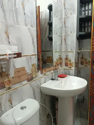 a bathroom with a sink and a toilet and a mirror at Riad Safir Medina Fes in Fès