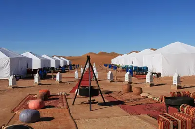 a group of tents in the middle of the desert at Luxury Berber Camp in El Gouera
