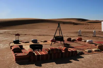 a desert with a bed in the middle of the desert at Luxury Berber Camp in El Gouera