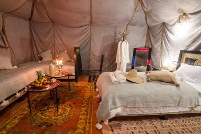 a bedroom with a bed in a tent at Luxury Camp Merzouga in Merzouga