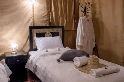 a bedroom with a bed with towels on it at Luxury Camp Merzouga in Merzouga
