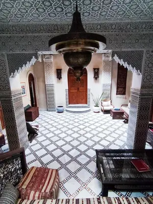 a large room with a large foyer with a large fountain at Riad le petit ksar in Meknès