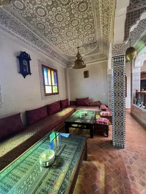a living room with a couch and a table at Riad le petit ksar in Meknès