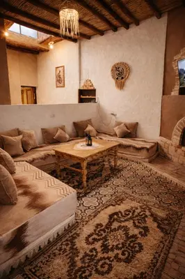 a living room with a couch and a table at Chez aubazine in Merzouga