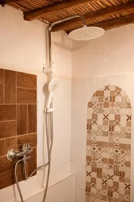 a bathroom with a shower with a shower head at Chez aubazine in Merzouga