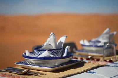 a group of blue and white dishes on a table at Desert Luxury Camp Morocco in Merzouga