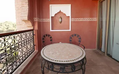 a balcony with a table and two chairs at Borj Des Cascades & Spa in Ouzoud
