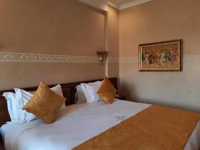 a bedroom with a large bed with white sheets and pillows at Borj Des Cascades & Spa in Ouzoud