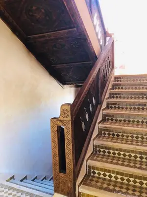 a staircase in a building with a wooden ceiling at Desert Villa Boutique Hotel Merzouga in Merzouga