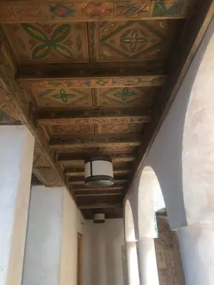 a ceiling in a building with a painting on it at Desert Villa Boutique Hotel Merzouga in Merzouga