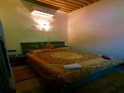 a bedroom with a bed in a room with a window at Hostel Rcif in Fès