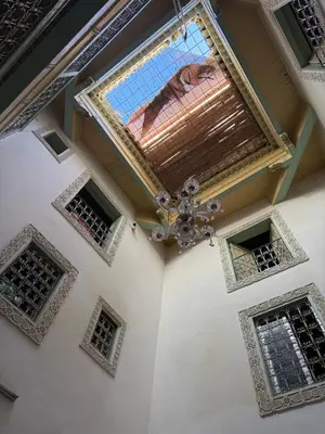 a ceiling of a building with a chandelier and windows at Hostel Rcif in Fès