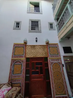a room with two doors in a building at Hostel Rcif in Fès