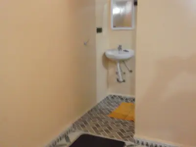 a small bathroom with a sink and a sink at Tifinagh Guest House in Merzouga
