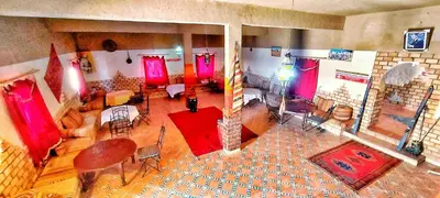 an overhead view of a living room with red curtains at Dar Gamra in Merzouga