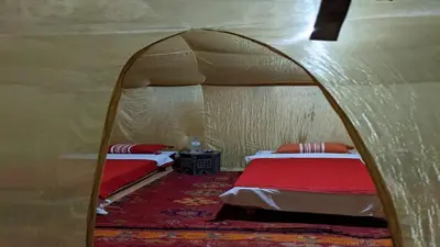 a room with two beds in a tent at Dar Gamra in Merzouga