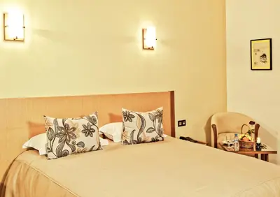 a hotel room with a bed with two pillows at Across Hotels & Spa in Fès