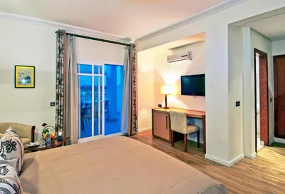 a hotel room with a bed and a desk and a television at Across Hotels & Spa in Fès