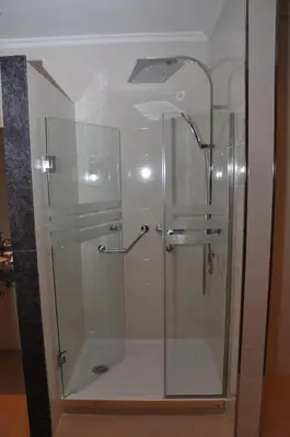 a shower with a glass door in a bathroom at Across Hotels & Spa in Fès