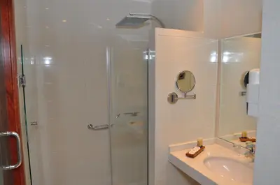 a bathroom with a shower and a sink at Across Hotels & Spa in Fès