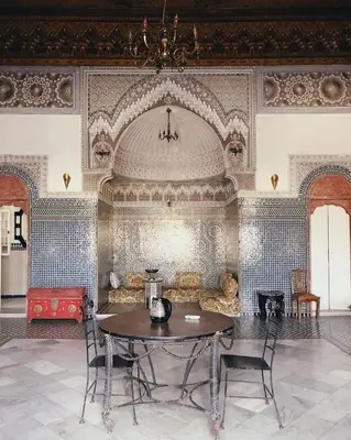 a living room with a table and a couch at suite in a XVIIIe palace in Fès