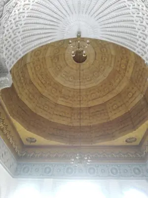 a ceiling of a building with a wooden at suite in a XVIIIe palace in Fès