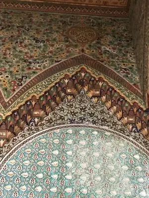 a room with a ceiling with a patterned floor at suite in a XVIIIe palace in Fès