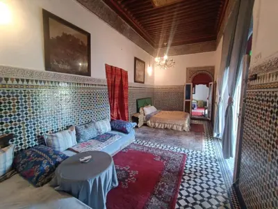 a living room with a couch and a table at suite in a XVIIIe palace in Fès
