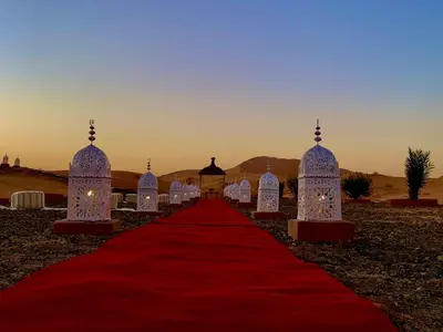 a red carpet leading to a wedding in the desert at Palmyra Luxury Camp in Merzouga