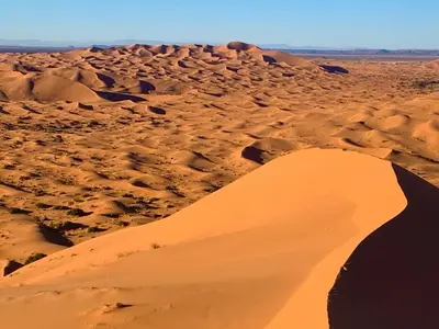 a sand dune in the middle of a desert at Palmyra Luxury Camp in Merzouga