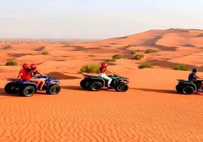 a group of people riding on atvs in the desert at Desert Luxury Tented & Activities in Hassilabied