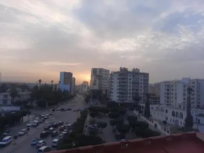 an aerial view of a city with buildings and cars at Hôtel Volubilis Meknès in Meknès